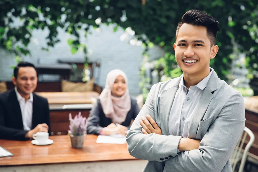 54702709 - portrait of asian businessman leader on the foreground of his team
